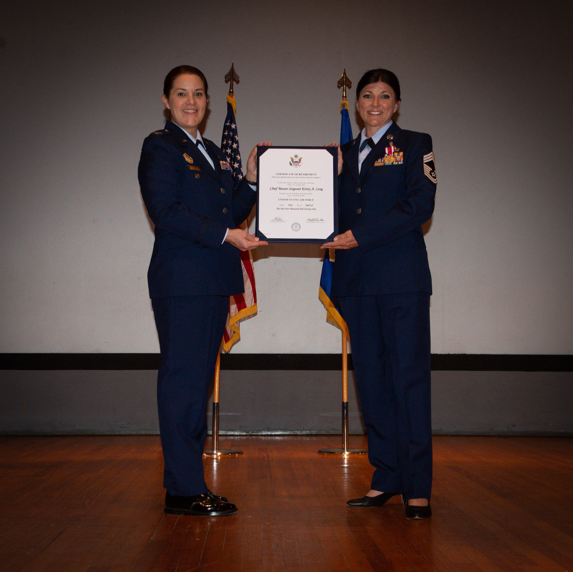 (left) Col. Kay Beigh, Individual Mobilization Assistant to the Commander, 96th Test Wing, Air Force Material Command, Eglin Air Force Base, Fla., presents Chief Master Sgt. Kristy Long, 44th Fighter Group senior enlisted leader, with a retirement certificate during Long's retirement ceremony at Eglin AFB, April 1. Beigh was the presiding official and former commander chief Long worked with. (U.S. Air Force photo by Master Sgt. Jeremy Roman)