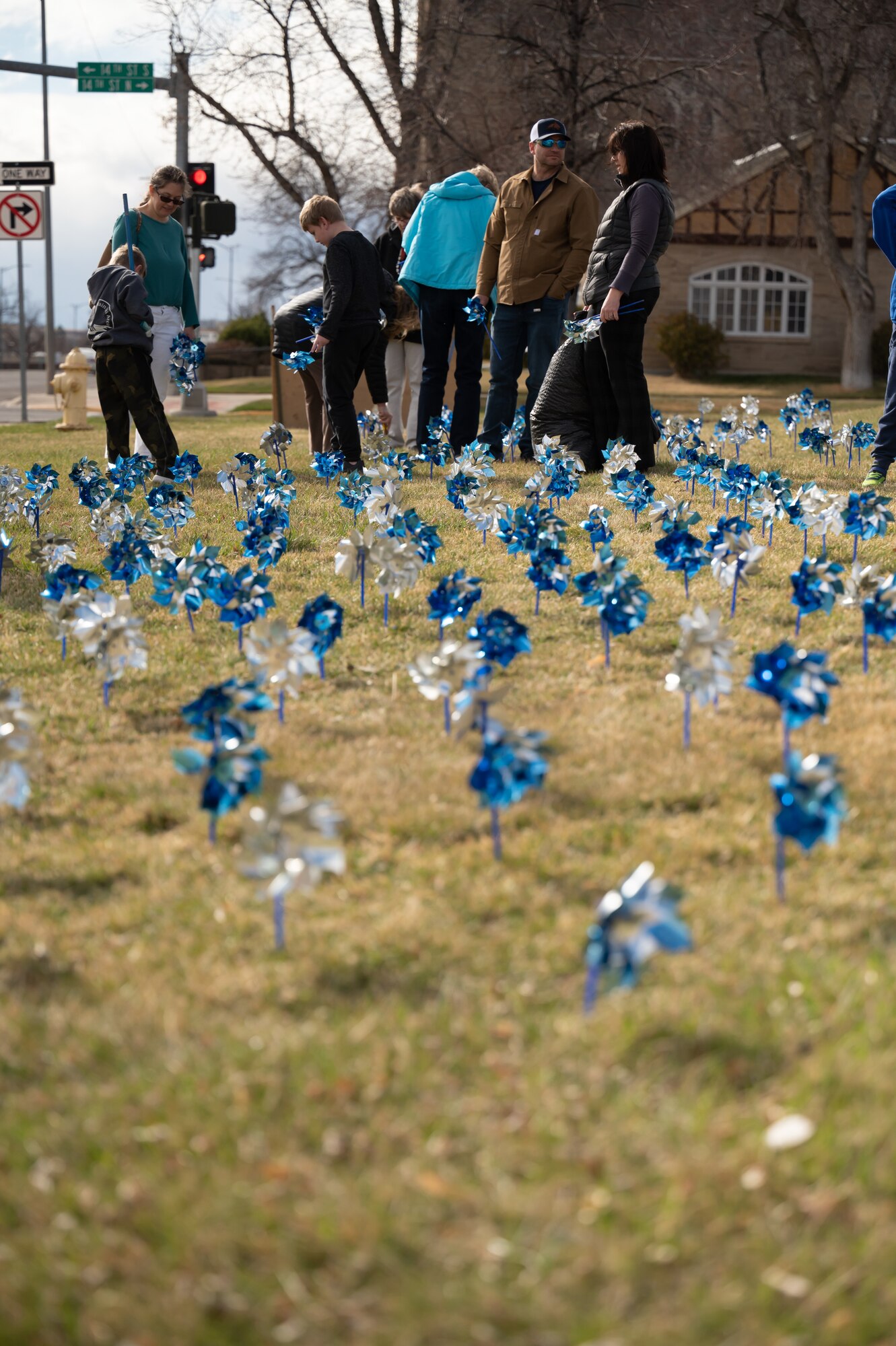 Volunteers plant pinwheels April 4, 2022, in front of the Paris Gibson Square Museum of Art in Great Falls, Mont.