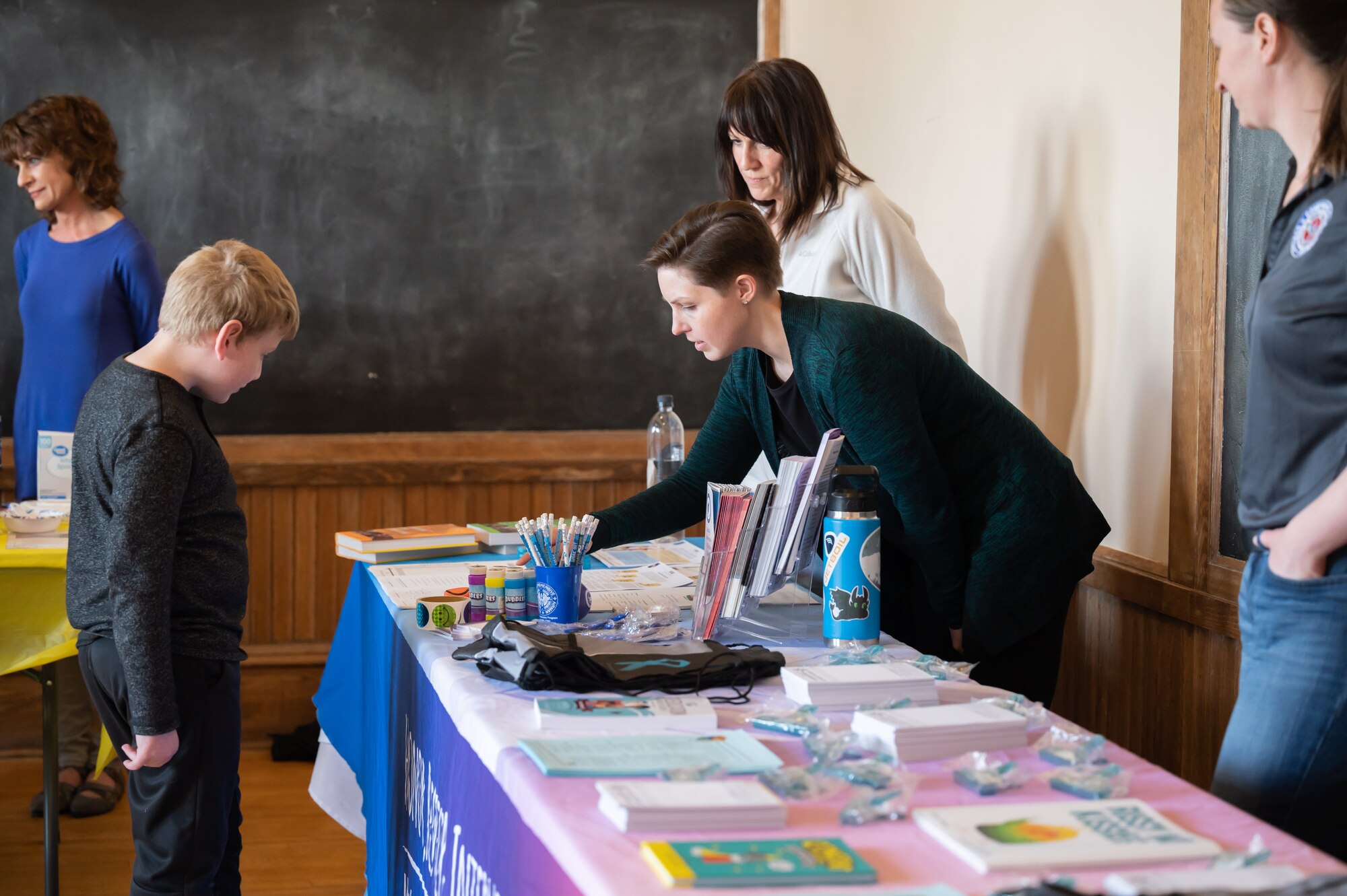 Chelsea Garson, 341st Operational Medical Readiness Squadron family advocacy nurse, speaks to an attendee during the Threads of Connection event April 4, 2022, at the Paris Gibson Square Museum of Art in Great Falls, Mont.