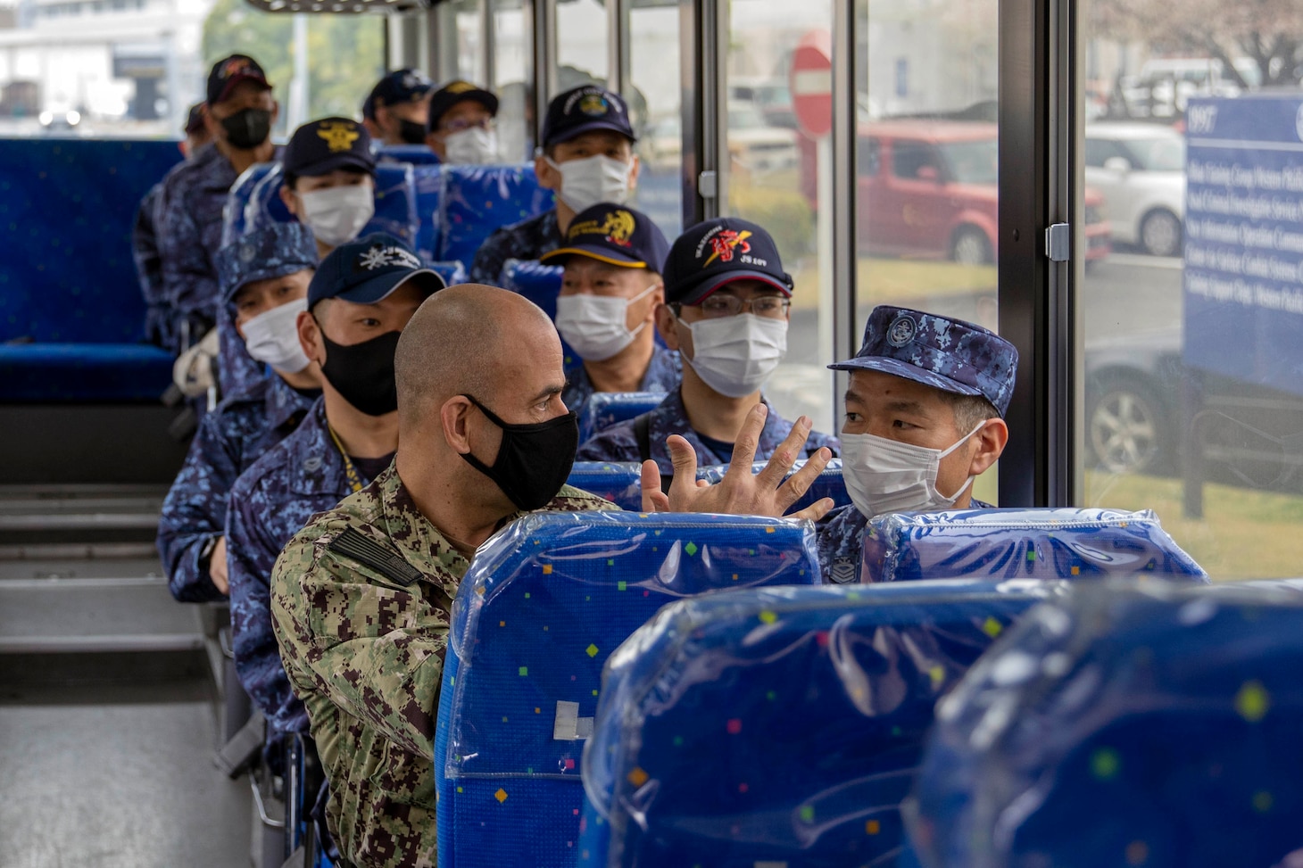 220405-N-MM501-1059 YOKOSUKA, Japan (April 5, 2022) Commander, Task Force 73 Command Master Chief Jonathan Carter speaks with a Japan Maritime Self-Defense Force (JMSDF) Sailor while transiting to Funakoshi Navy Base for a ship tour during the U.S. 7th Fleet Sailor of the Year Week, April 5. U.S. 7th Fleet conducts forward-deployed naval operations in support of U.S. national interests in the Indo-Asia-Pacific area of operations. As the U.S. Navy’s largest numbered fleet, 7th Fleet interacts with 35 other maritime nations to build maritime partnerships that foster maritime security, promote stability, and prevent conflict. (U.S. Navy photo by Mass Communication Specialist 2nd Class Shannon Burns)