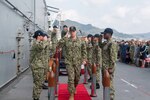 SASEBO, Japan (April 7, 2022) Capt. Shockey Snyder, seventh commanding officer of the forward-deployed amphibious assault ship USS America (LHA 6), departs the change-of-command on the ship's flight deck. America, lead ship of the America Amphibious Ready Group, is operating in the U.S. 7th Fleet area of responsibility to enhance interoperability with allies and partners, and serve as a ready response force to defend peace and stability in the Indo- Pacific region. (U.S. Navy photo by Mass Communication Specialist Seaman Matthew Bakerian)