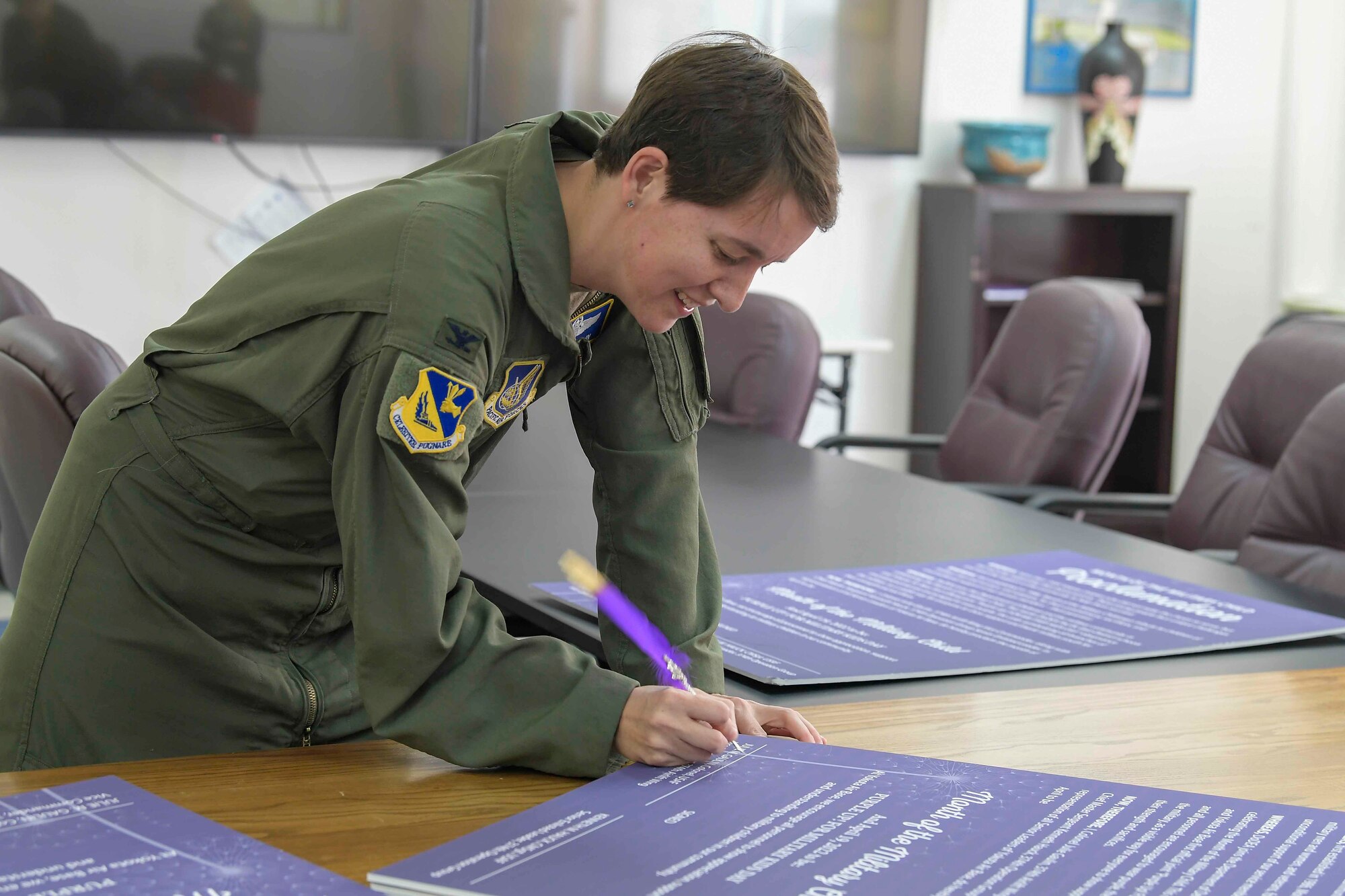 Col. Julie Gaulin, 374th Airlift Wing vice commander, signs a Month of the Military Child proclamation at Yokota Air Base, Japan, April 7, 2022.