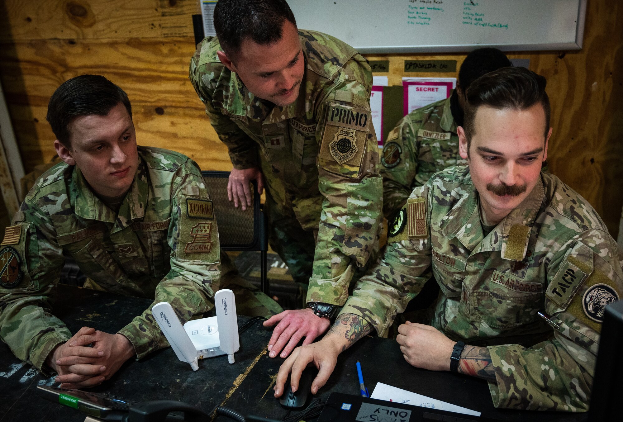 A U.S. Air Force Tactical Air Control Party Team Leader, from the 4th Air Support Operations Group, works alongside Airmen, assigned to the 606th Air Control Squadron and the 1st Combat Communications Squadron, to develop products for air space coordination and control in Romania, March 6, 2022. 435th Air Ground Operations Wing TACP Operators and 1 CBCS Airmen integrate with 606 ACS personnel, assigned to the 31st Fighter Wing, and NATO Allies to enhance airspace awareness and ensure the safety and security of Alliance air operations. (U.S Air Force photo by Staff Sgt. Jacob Wongwai)