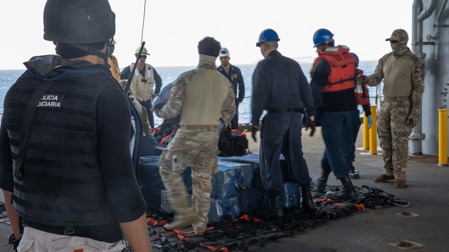 220406-N-TI693-1185

ATLANTIC OCEAN (April 6, 2022) - A Judicial Police officer from Cabo Verde, monitors Sailors, and U.S. Coast Guardsmen aboard the Expeditionary Sea Base USS Hershel "Woody" Williams (ESB 4), prepare seized contraband for offload to the Cabo Verdean authorities, April 6, 2022. Hershel "Woody" Williams is on a scheduled deployment in the U.S. Sixth Fleet area of operations in support of U.S. national interests and security in Europe and Africa. (U.S. Navy photo by Mass Communication Specialist 1st Class Fred Gray IV/Released)