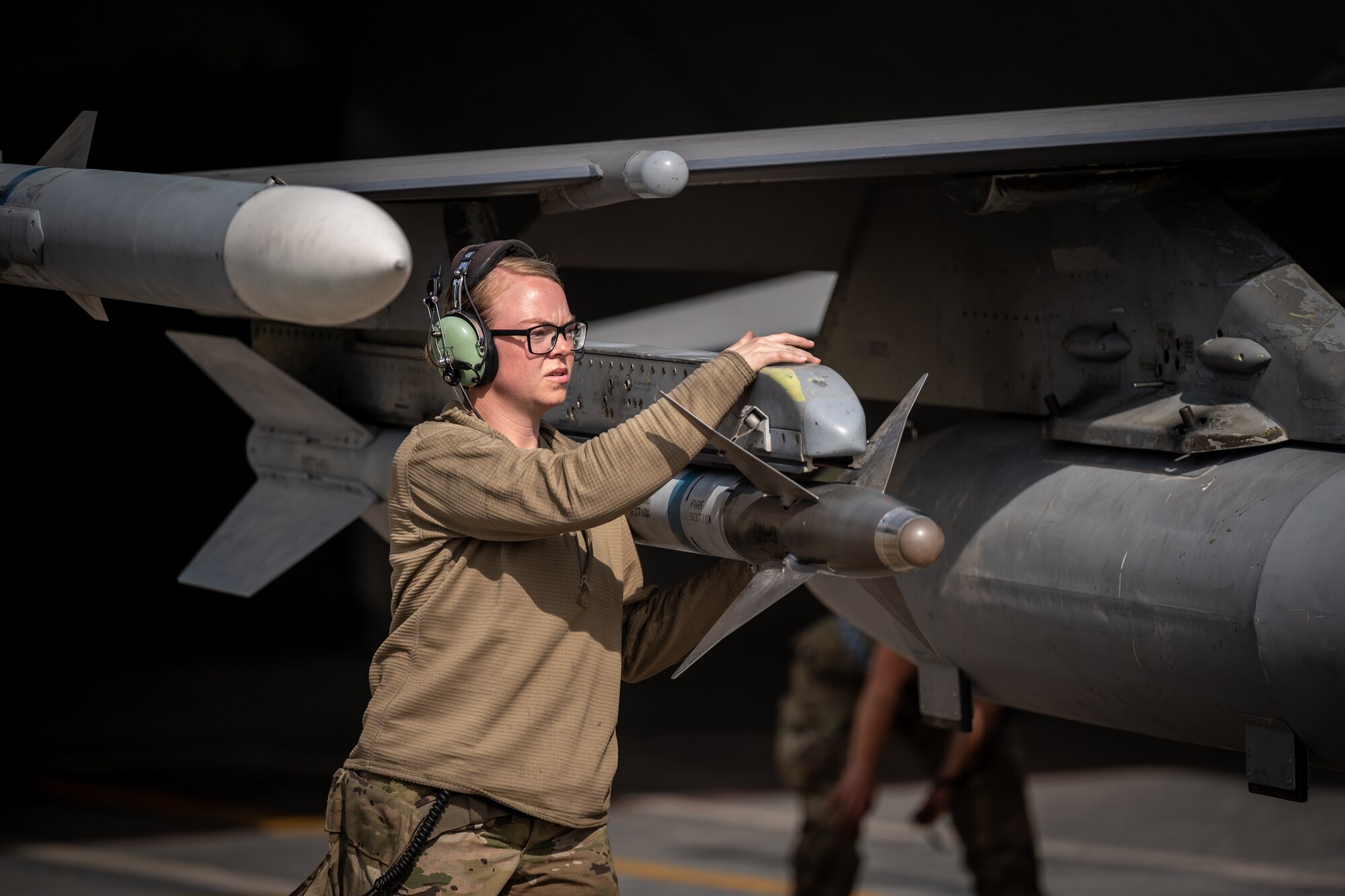 Staff Sgt. Savanna Huntzinger, 55th Expeditionary Fighter Generation Squadron weapons load crew member, performs end of runway arming prior to launching an F-16 Fighting Falcon for its departure from a Pakistan operational air force base, March 5, 2022. Falcon Talon 2022, an Agile Combat Employment operation, is the first bilateral training event between the United States and Pakistan since 2019. (U.S. Air Force photo by Master Sgt. Christopher Parr).
