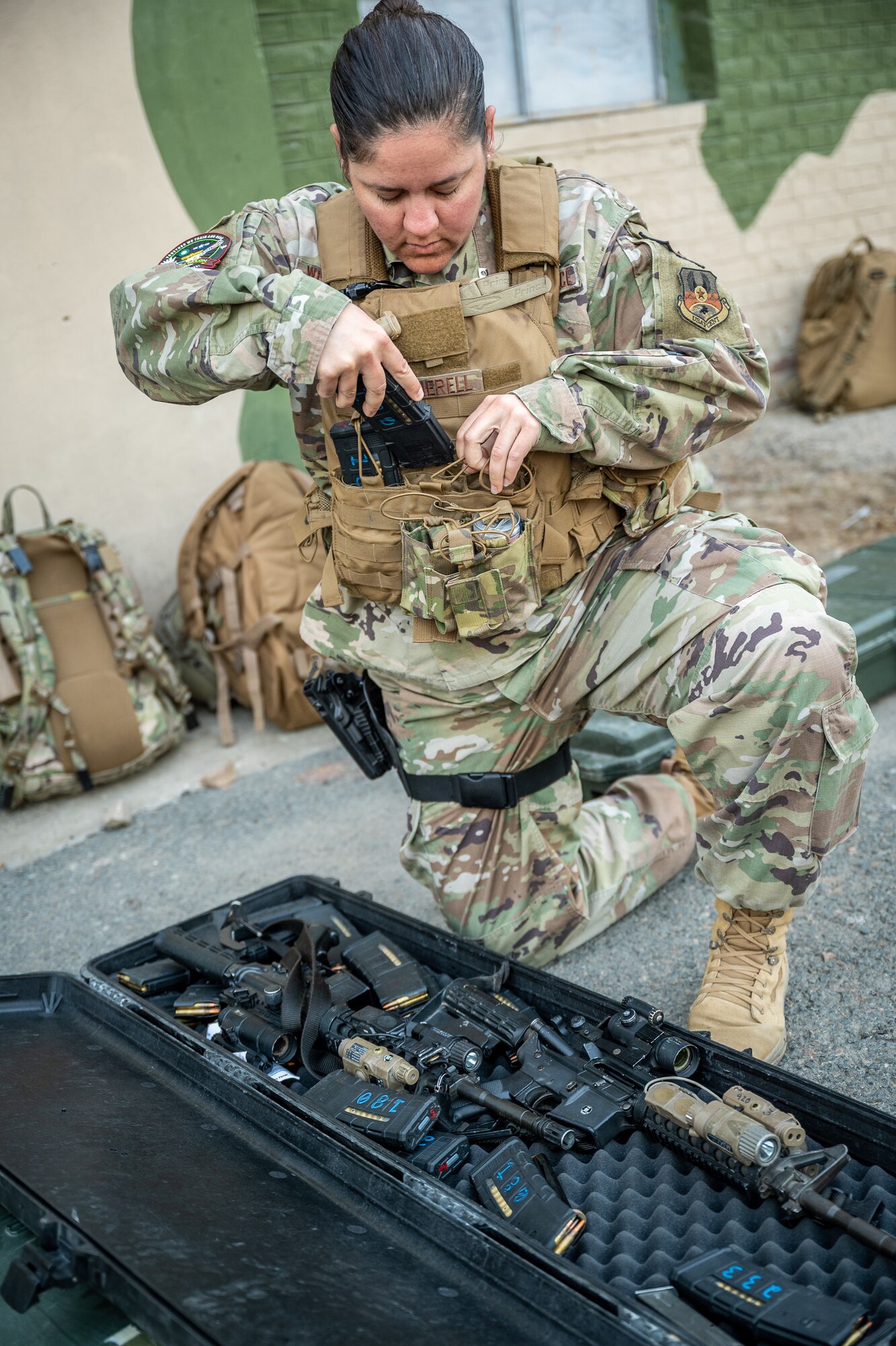 Staff Sgt. Paige Wetherell, 332d Expeditionary Security Forces Squadron, loads ammunition into her tactical vest prior to her shift guarding U.S. Air Force aircraft at a Pakistan operational air force base, March 4, 2022. Wetherell, along with other U.S. Air Force members from across the Air Forces Central area of responsibility, deployed to Pakistan in support of Falcon Talon 2022. This Agile Combat Employment operation, held Feb. 28 - March 4, 2022, is the first bilateral training event between the United States and Pakistan since 2019. (U.S. Air Force photo by Master Sgt. Christopher Parr)