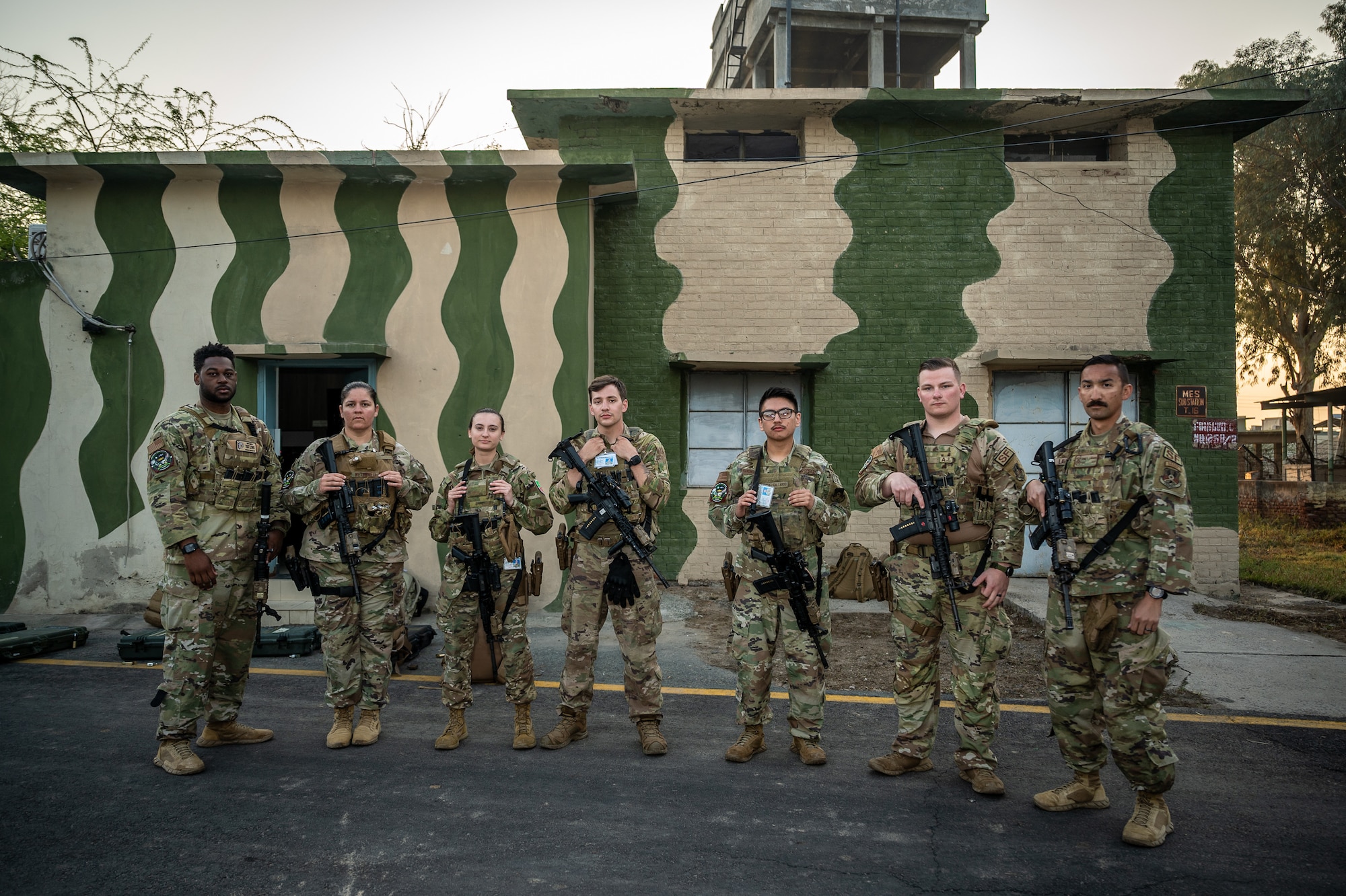 U.S. Air Force Security Forces members pose for a photo before beginning their shift guarding aircraft at a Pakistan operational air force base, March 4, 2022. U.S. Air Force members from across the Air Forces Central area of responsibility deployed to Pakistan in support of Falcon Talon 2022. This Agile Combat Employment operation, held Feb. 28 - March 4, 2022, is the first bilateral training event between the United States and Pakistan since 2019. (U.S. Air Force photo by Master Sgt. Christopher Parr)