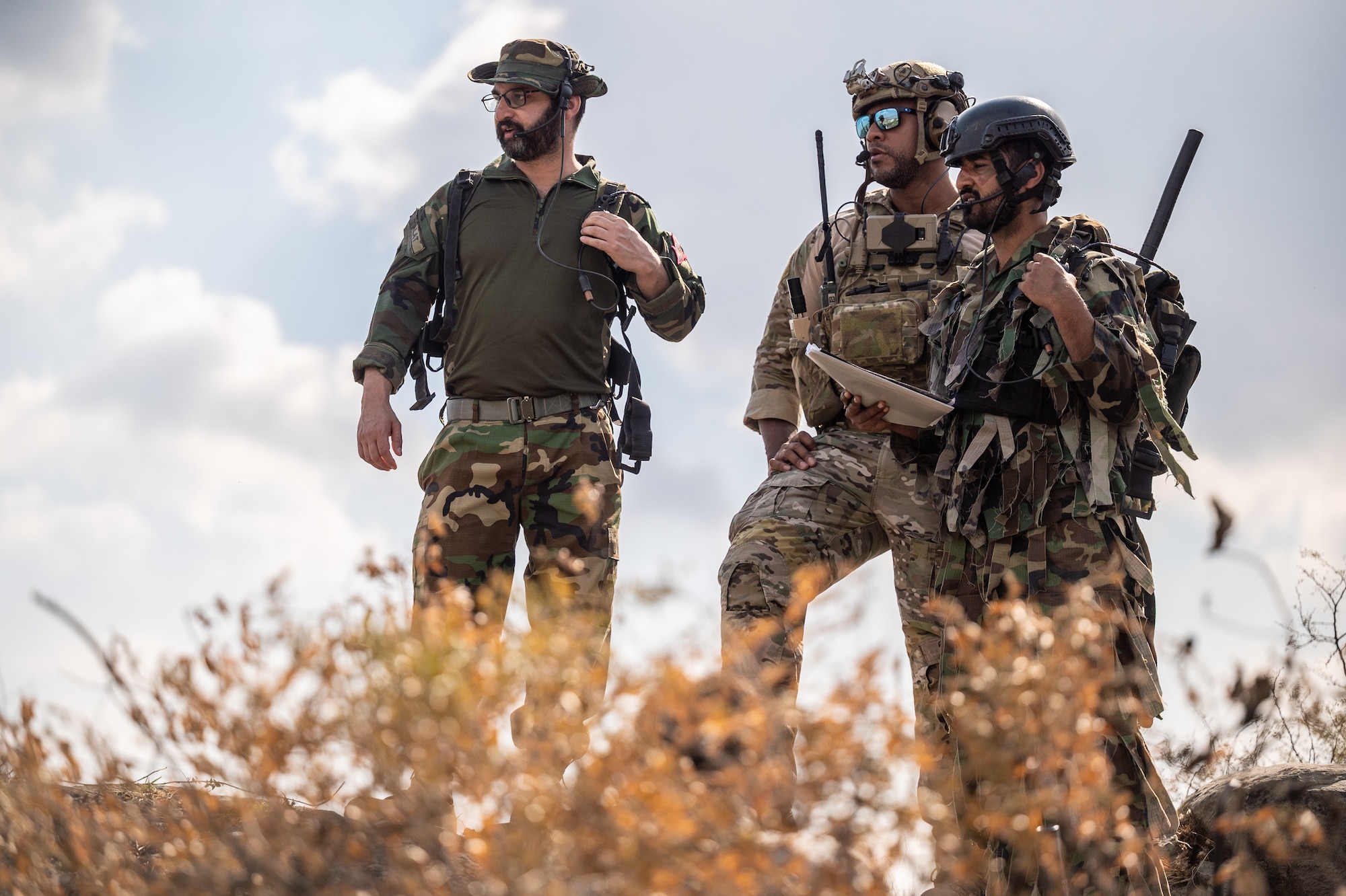 Tech. Sgt. Brandon Tatum, Air Warfare Center chief of joint terminal attack control training, works with Pakistan commandos to locate and coordinate various targets of opportunity during a training scenario at a Pakistan military range, March 1, 2022. The partner nation training conducted was part of Falcon Talon 2022, an Agile Combat Employment operation and the first bilateral training event between the U.S. and Pakistan since 2019. (U.S. Air Force photo by Master Sgt. Christopher Parr)