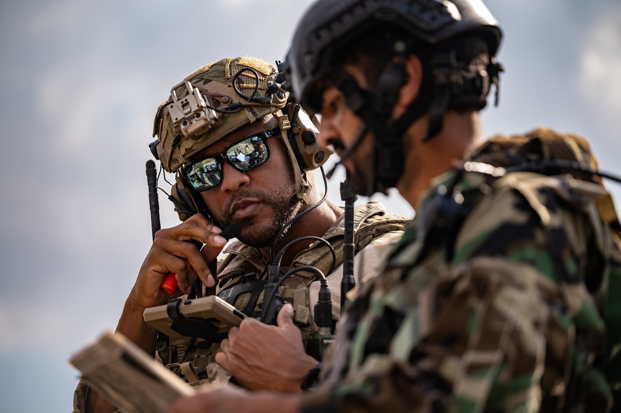 Tech. Sgt. Brandon Tatum, Air Warfare Center chief of joint terminal attack control training, works with Pakistan commandos to locate and coordinate various targets of opportunity during a training scenario at a Pakistan military range, March 1, 2022. The partner nation training conducted was part of Falcon Talon 2022, an Agile Combat Employment operation and the first bilateral training event between the U.S. and Pakistan since 2019. (U.S. Air Force photo by Master Sgt. Christopher Parr)