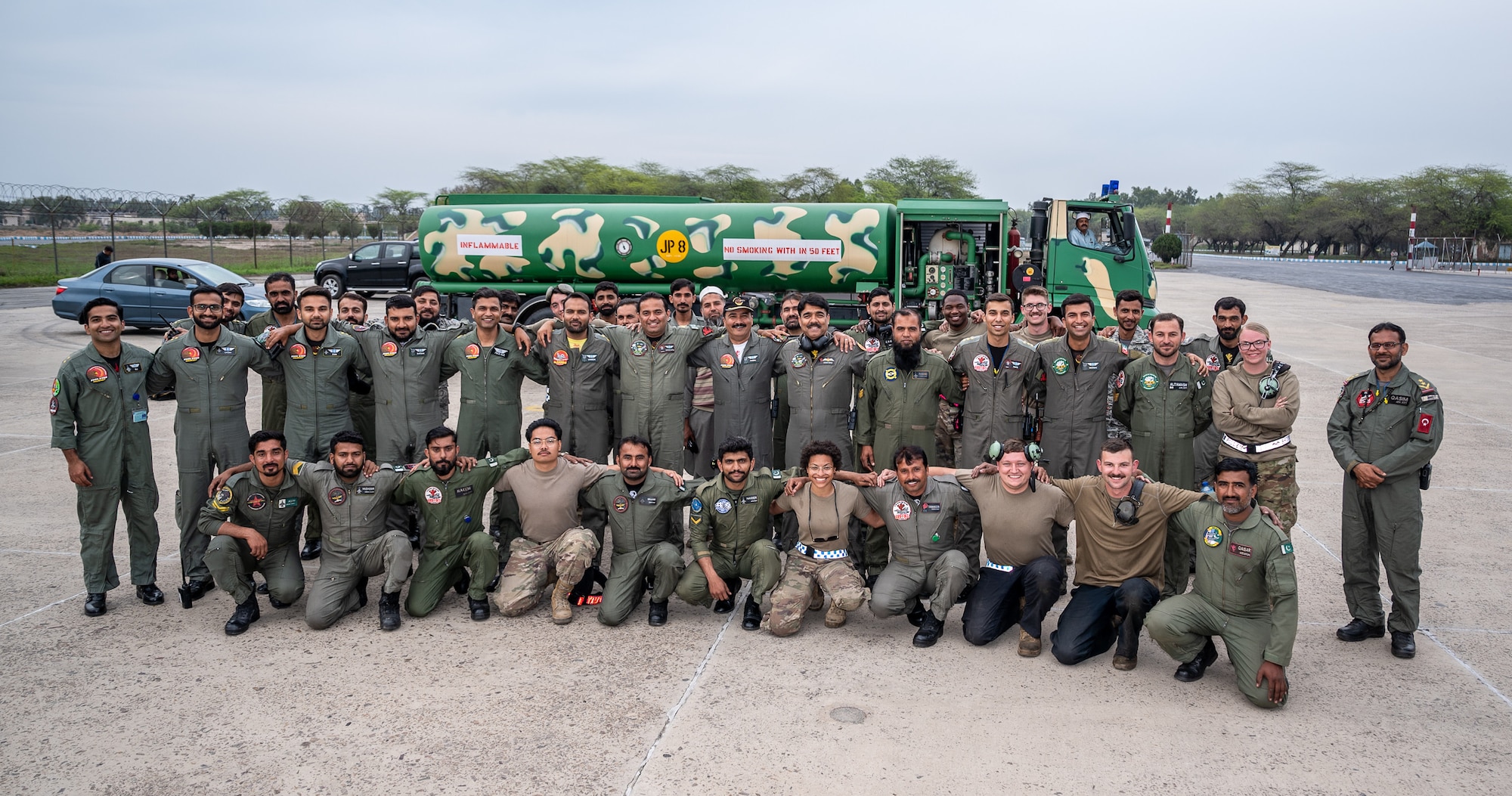 Airmen from the U.S. and Pakistan Air Forces pose together for a photo following a successful Integrated Combat Turnaround, March 2, 2022, as part of Falcon Talon 2022. ICTs are rapid re-arming and refueling of aircraft with engines still running, reducing ground time to quickly resume air operations. The Agile Combat Employment operation, held Feb. 28 - March 4, 2022, is the first bilateral training event between the two countries since 2019. (U.S. Air Force photo by Master Sgt. Christopher Parr)