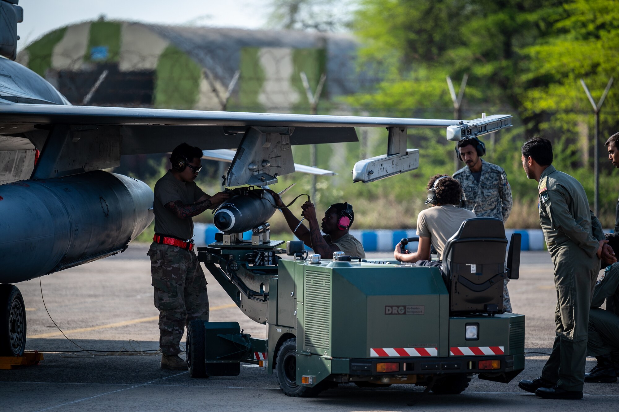 Staff Sgt. Avary Kemp, Senior Airman Joshua Chantharatry and Airman First Class Calease Brown, 55th Expeditionary Fighter Generation Squadron weapons load crew members, demonstrate how to perform a rapid re-arming of an F-16 aircraft at a Pakistan operational air force base during Integrated Combat Turnaround training, March 3, 2022. ICTs are rapid re-arming and refueling of aircraft with engines still running, reducing ground time to quickly resume air operations. Falcon Talon 2022, an Agile Combat Employment operation, held Feb. 28 – March 4, 2022, is the first bilateral training event between the two countries since 2019. (U.S. Air Force photo by Master Sgt. Christopher Parr)