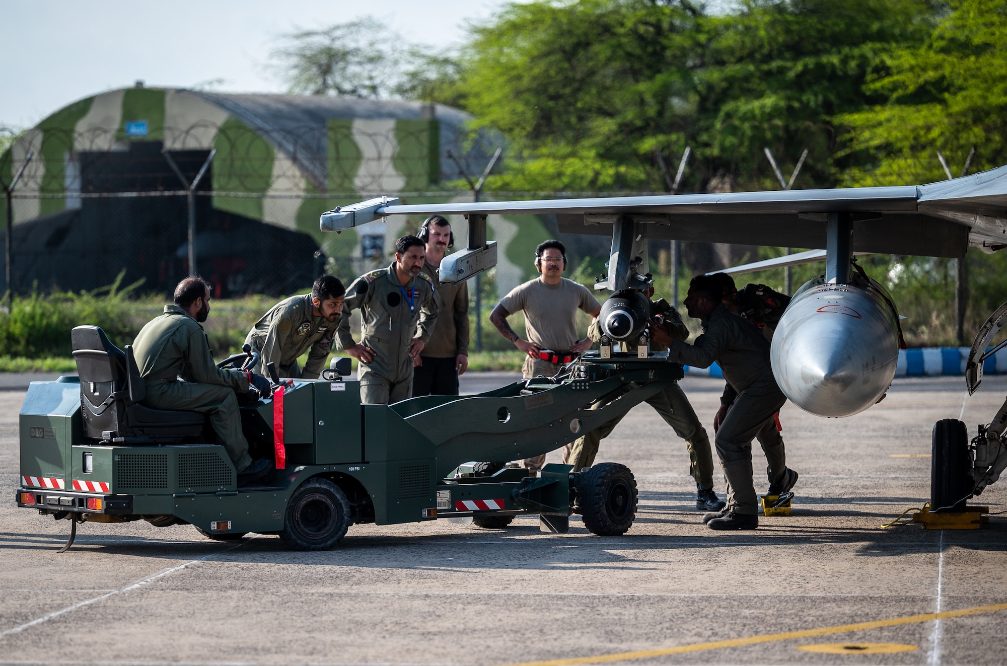 Airmen from the U.S. and Pakistan Air Forces work together to conduct an Integrated Combat Turnaround, March 3, 2022, as part of Falcon Talon 2022. ICTs are rapid re-arming and refueling of aircraft with engines still running, reducing ground time to quickly resume air operations. The Agile Combat Employment operation, held Feb. 28 - March 4, 2022, is the first bilateral training event between the two countries since 2019. (U.S. Air Force photo by Master Sgt. Christopher Parr)