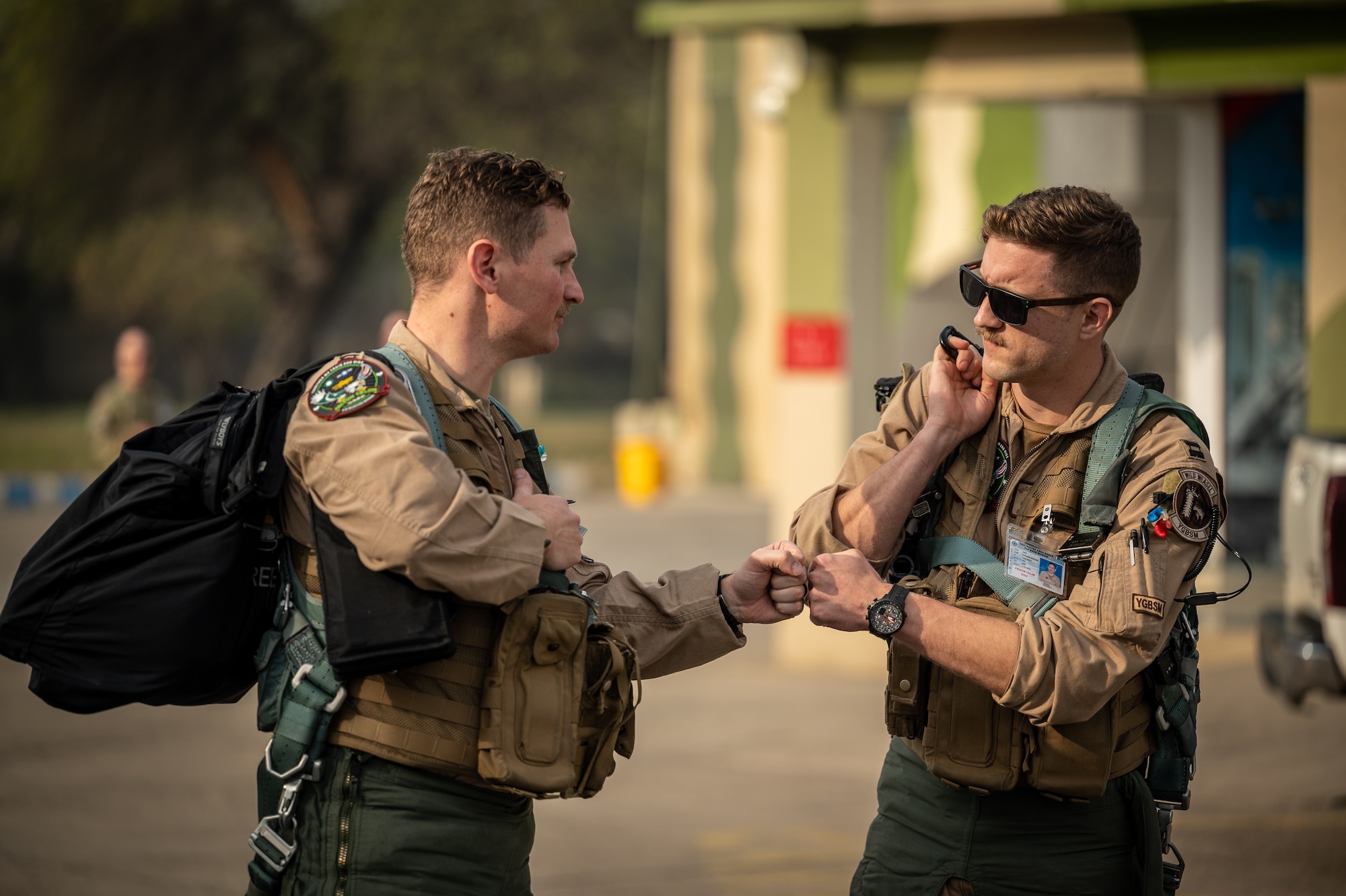 332d Air Expeditionary Wing F-16 Fighting Falcon aircraft pilots fist bump as they head out for a training sortie Feb. 28, 2022, with Pakistan Air Force partners during Falcon Talon 2022 at a PAF operational base. This Agile Combat Employment operation is the first bilateral training event between the United States and Pakistan since 2019. (U.S. Air Force photo by Master Sgt. Christopher Parr)