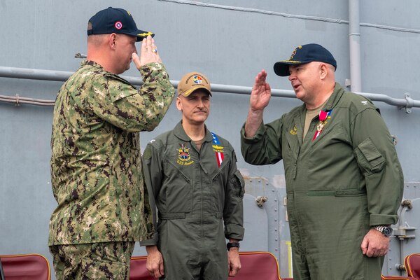 SASEBO, Japan (April 7, 2022) Capt. Shockey Snyder, left, seventh commanding officer of the forward-deployed amphibious assault ship USS America (LHA 6), assumes command from Capt. Ken Ward during a change-of-command ceremony on the ship's flight deck. America, lead ship of the America Amphibious Ready Group, is operating in the U.S. 7th Fleet area of responsibility to enhance interoperability with allies and partners, and serve as a ready response force to defend peace and stability in the Indo-Pacific region. (U.S. Navy photo by Mass Communication Specialist Seaman Matthew Bakerian)