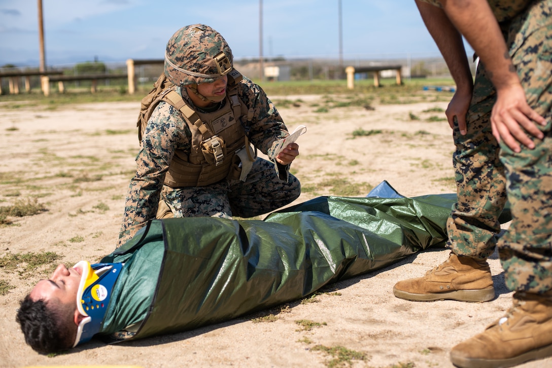 U.S. Marine Corps Cpl. Ryan Nascimento, a chemical, biological, radiological and nuclear defense specialist, reads off casualty information for a nine-line medical evacuation request during a Combat Lifesaver Course practical application at Marine Corps Base Camp Pendleton, California, March 30, 2022. CLS is a three-day course that teaches Marines lifesaving medical techniques to eliminate preventable loss of life on the battlefield.