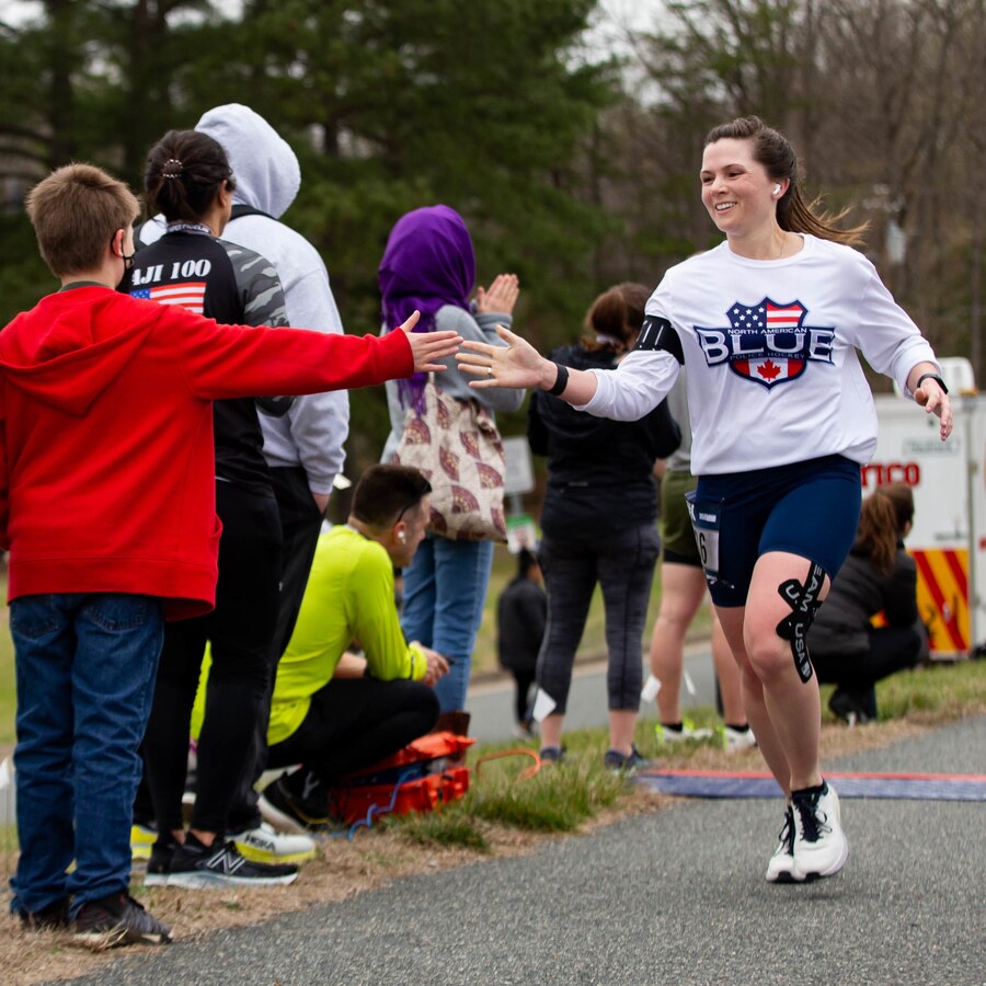 A participant of the Marine Corps Marathon 17.75k nears the finish line in Dumfries, Virginia, March 26, 2022. The event promotes physical fitness, generate goodwill in the community, and showcase the organizational skills of the Marine Corps. (U.S. Marine Corps photo by Cpl. Mitchell Johnson)
