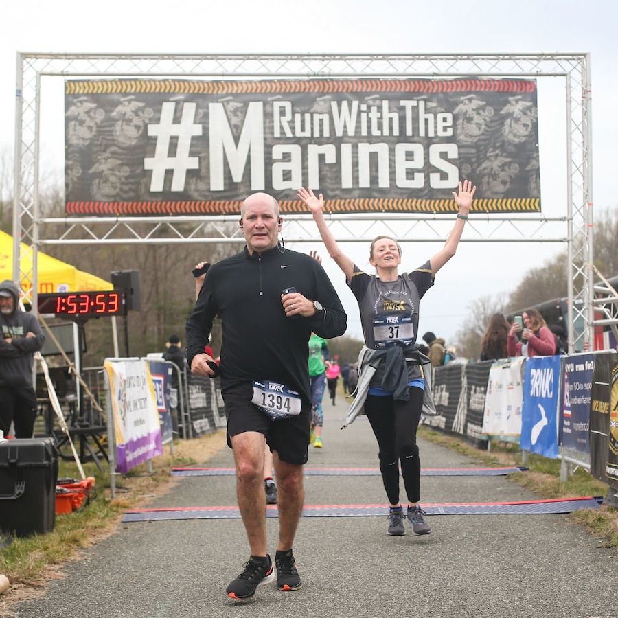 Participants of the Marine Corps Marathon 17.75k cross the finish line in Dumfries, Virginia, March 26, 2022. The event promotes physical fitness, generate goodwill in the community, and showcase the organizational skills of the Marine Corps. (U.S. Marine Corps photo by Cpl. Mitchell Johnson)