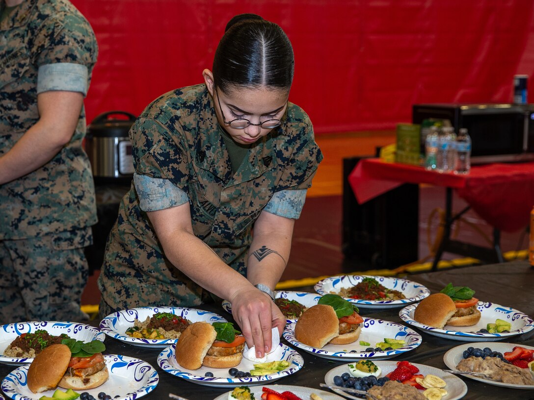 U.S. Marines participate in a cooking competition hosted by the Single Marine Program in partnership with the Defense Commissary Agency on Marine Corps Base Quantico, Virginia, March 31, 2022. The event included a cooking, shopping, and nutrition based course; practical application; and a cooking competition. During the competition, the Marines had one and a half hours to make a week's’ worth of breakfasts, lunches, dinners, and snacks using only an Instant Pot and microwave. (US Marine Corps photo by Lance Cpl. Kayla LaMar)