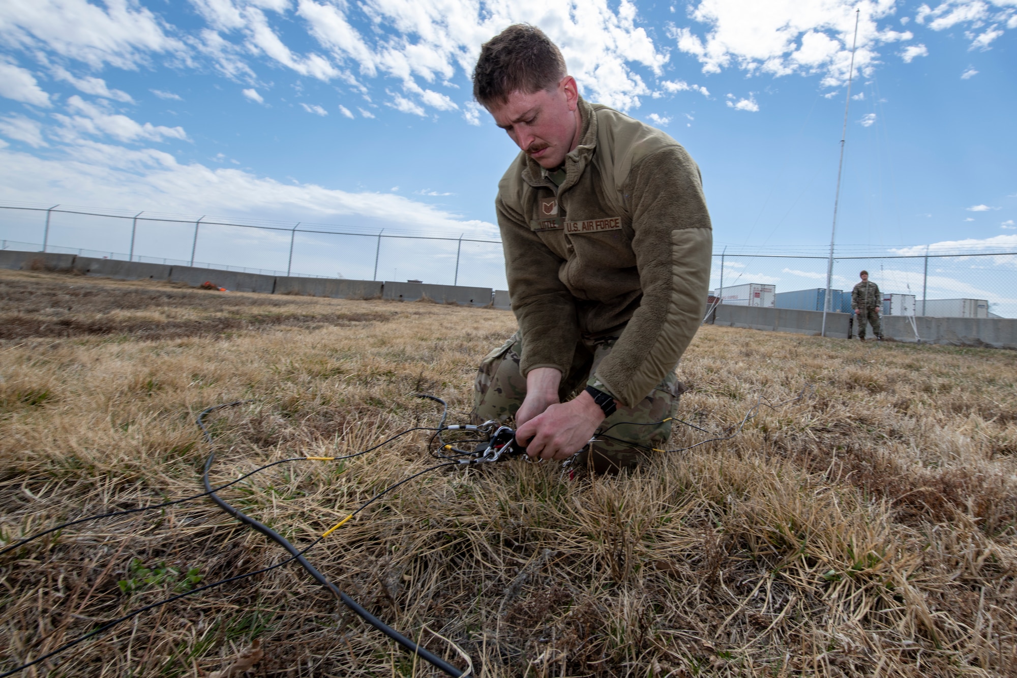 Airman plugs in cables.