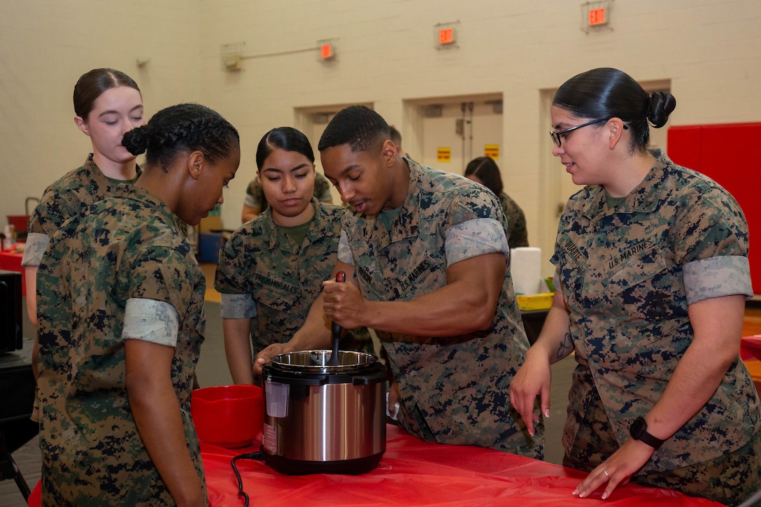 U.S. Marines prepare meals during a cooking, shopping, and nutrition based course hosted by the Single Marine Program on Marine Corps Base Quantico, Virginia, March 30, 2022. The two day event consisted of knowledge and skills training, and practical application where Marines showcased the skills they learned through an end of course cook-off.  (U.S. Marine Corps Photo by Cpl. Mitchell Johnson)