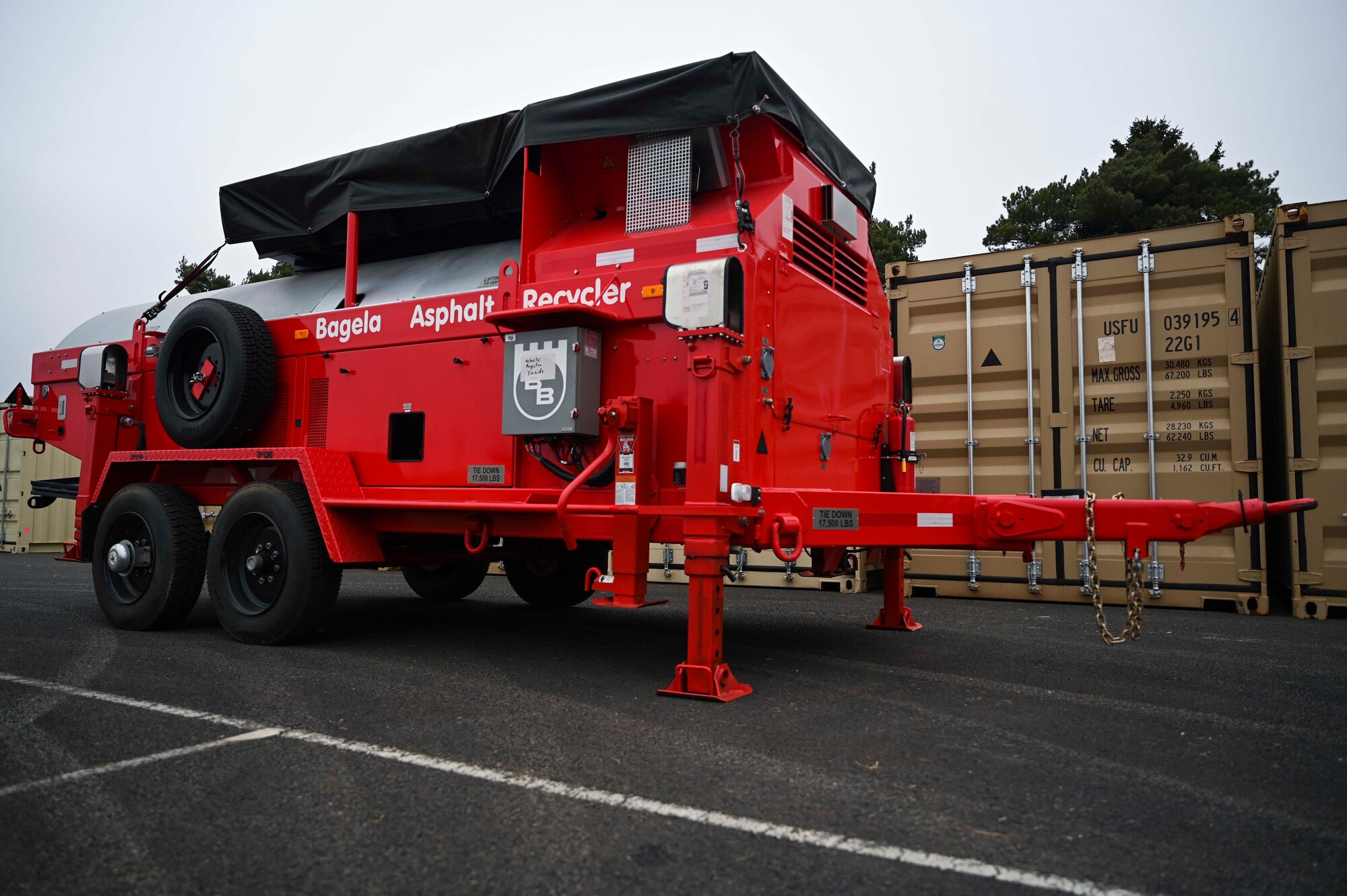 A KM T-2 asphalt recycling machine stands at Royal Air Force Mildenhall, England, March 30, 2022. The trailer recycles material into plant-grade asphalt to help patch holes in an airfield or street. (U.S. Air Force photo by Airman 1st Class Viviam Chiu)