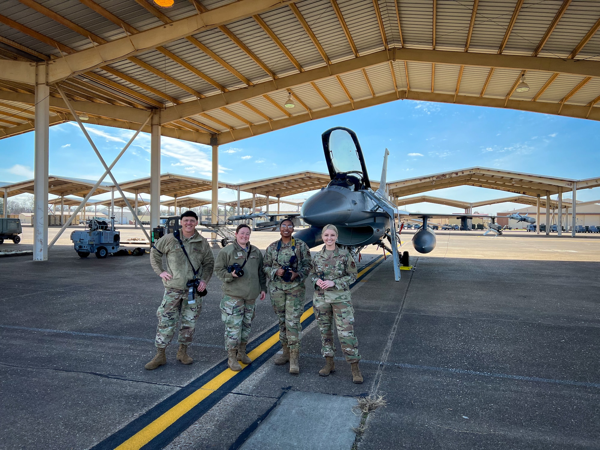 Members from the 301st Fighter Wing and 307th Bomb Wing pose in front of a F-16 Fighting Falcon at Barksdale Air Force Base, Louisiana on March 9, 2022. Public Affairs (PA) Specialists from the 301 FW and 307 BW conducted joint public affairs training to enhance readiness.