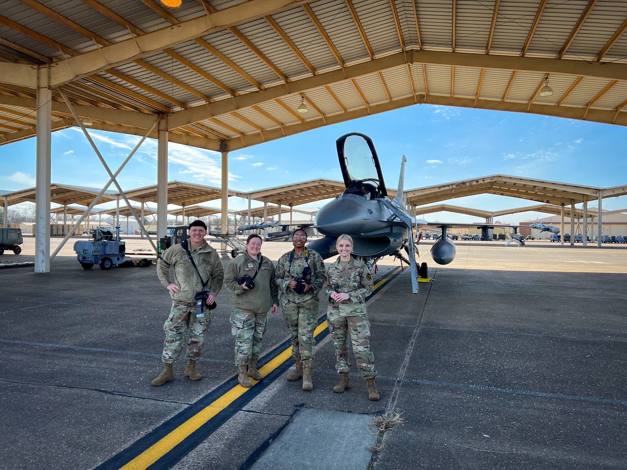 Members from the 301st Fighter Wing and 307th Bomb Wing pose in front of a F-16 Fighting Falcon at Barksdale Air Force Base, Louisiana on March 9, 2022. Public Affairs (PA) Specialists from the 301 FW and 307 BW conducted joint public affairs training to enhance readiness.