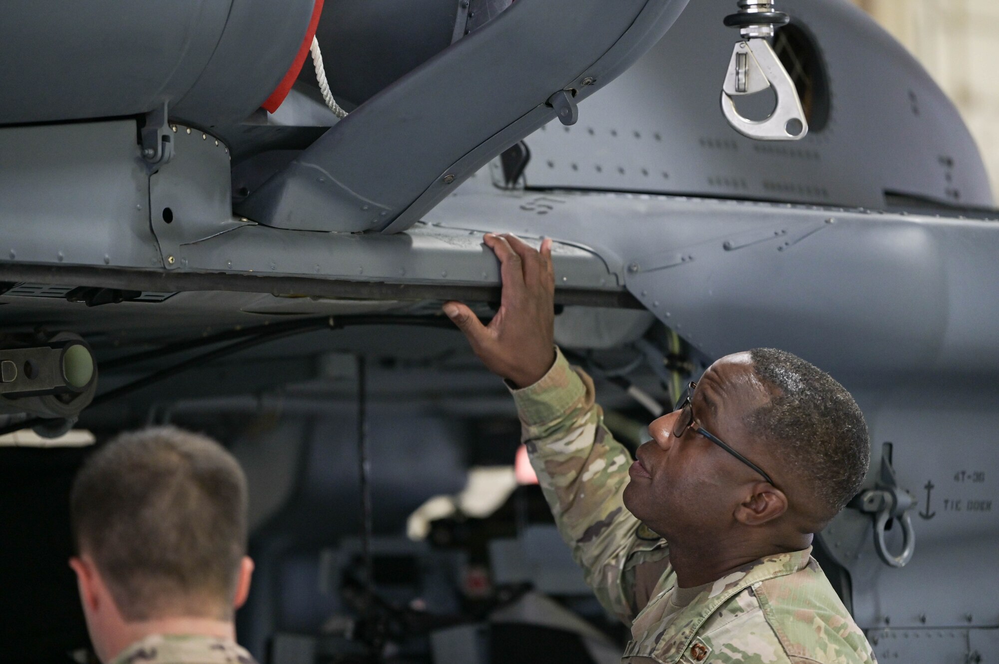 Service members from the 41st Rescue Generation Squadron talk with U.S. Air Force Maj. Gen. Stacey Hawkins, Air Combat Command director of logistics, engineering and force protection, about the differences between the HH-60G Pave Hawk and HH-60W Jolly Green II helicopters March 24, 2022, at Moody Air Force Base, Georgia. Moody retired its final HH-60G model helicopter in September of 2021. (U.S. Air Force photo by Senior Airman Rebeckah Medeiros)