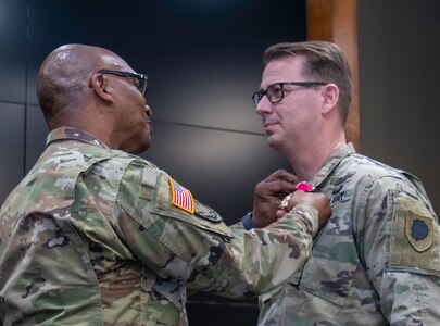 Sgt. Maj. David Owsley, of Forsyth, Plans, Training and Operations sergeant major, Illinois Army National Guard, receives the Legion of Merit for nearly 33 years of military service from Brig. Gen. Rodney Boyd, of Naperville, Assistant Adjutant General - Army and Commander of the Illinois Army National Guard, during a retirement ceremony April 1 at Camp Lincoln, Springfield Illinois.