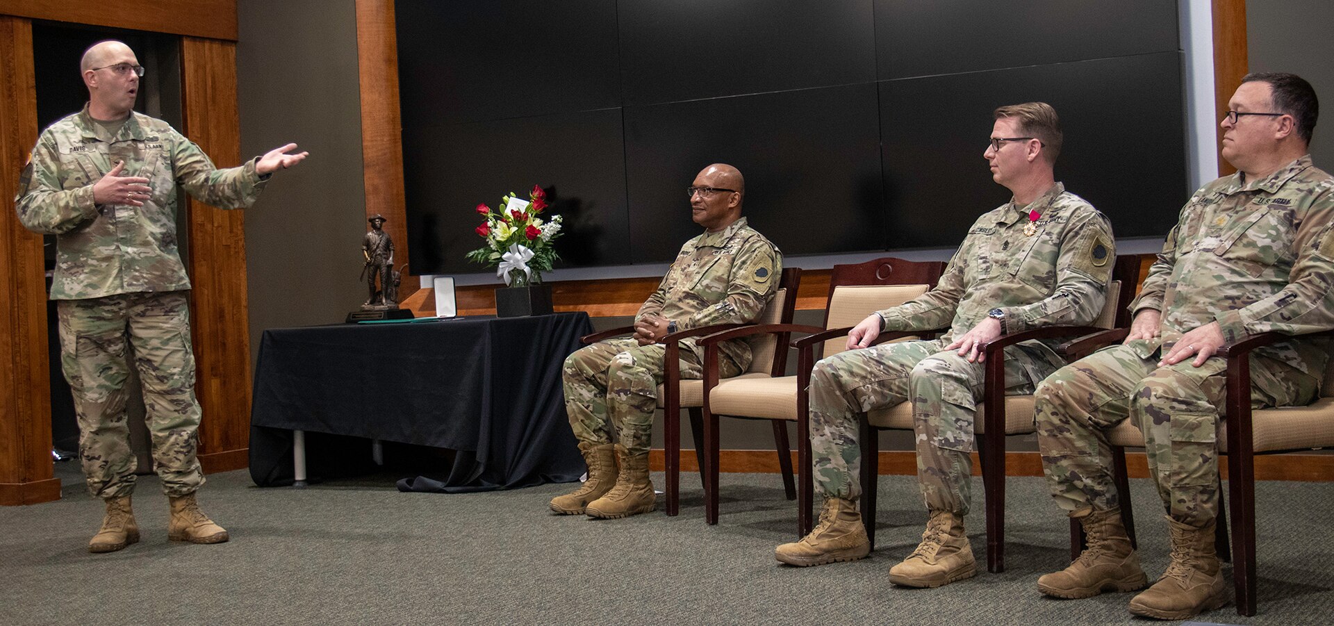 Col. Eric Davis, Director, Plans, Training and Operations, Illinois Army National Guard, thanks Sgt. Maj. David Owsley for his nearly 33 years of military service.