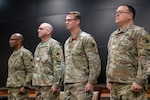 Sgt. Maj. David Owsley, of Forsyth, Illinois, second from right, stands at attention during the reading of the retirement order during the retirement ceremony April 1 at the Illinois Military Academy in Springfield, Illinois.