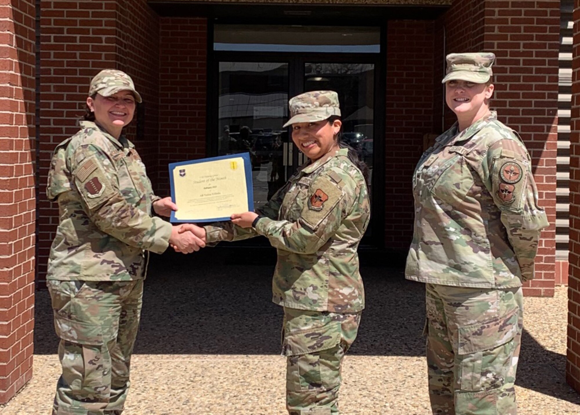 U.S. Air Force Col. Angelina Maguinness, 17th Training Group commander, and Senior Master Sgt. Heather Celano, 313th Training Squadron senior enlisted leader, presents Airman Yulisa Villeda, 315th Training Squadron student, the 17th TRG Student of the Month award for February 2022, Goodfellow Air Force Base, Texas, April 4, 2022. Villeda worked hard for her award and has shown her dedication to her squadron and the training she received at Goodfellow. (Courtesy photo)