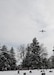 A KC-135 Stratotanker airplane flies over a cemetery