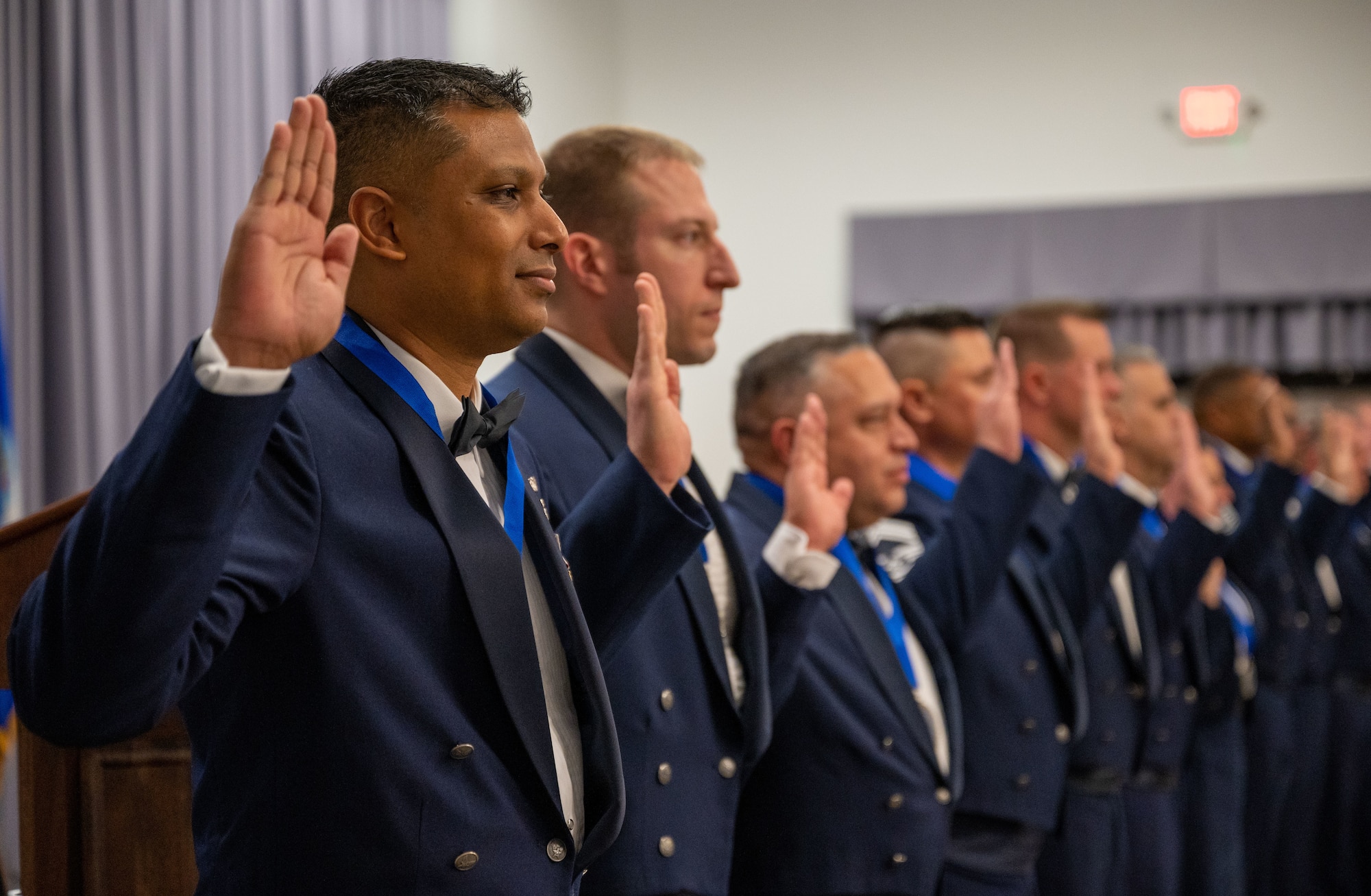 Chief Master Sgt. Troy Sahai, and other honorees, raise their hands during the Chief’s Charge at the 2022 Chief Induction ceremony at Dover Air Force Base, Delaware, April 2, 2022. The rank of chief master sergeant is the highest enlisted rank in the Air Force, with only one percent of the enlisted force structure reaching it. (U.S. Air Force photo by Airman 1st Class Cydney Lee)