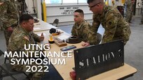 Three soldiers working at a maintenance competition event