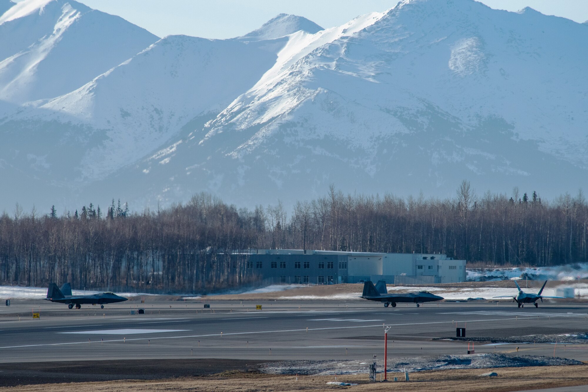 A photo of F-22 Raptors taxiing before takeoff.