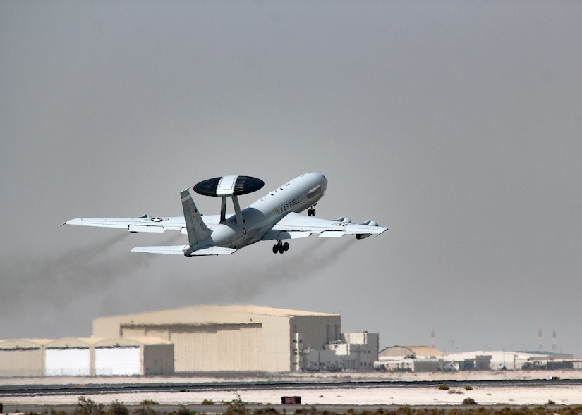 An aircraft takes off from a desert airport.