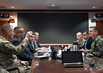 People sitting at a conference table.