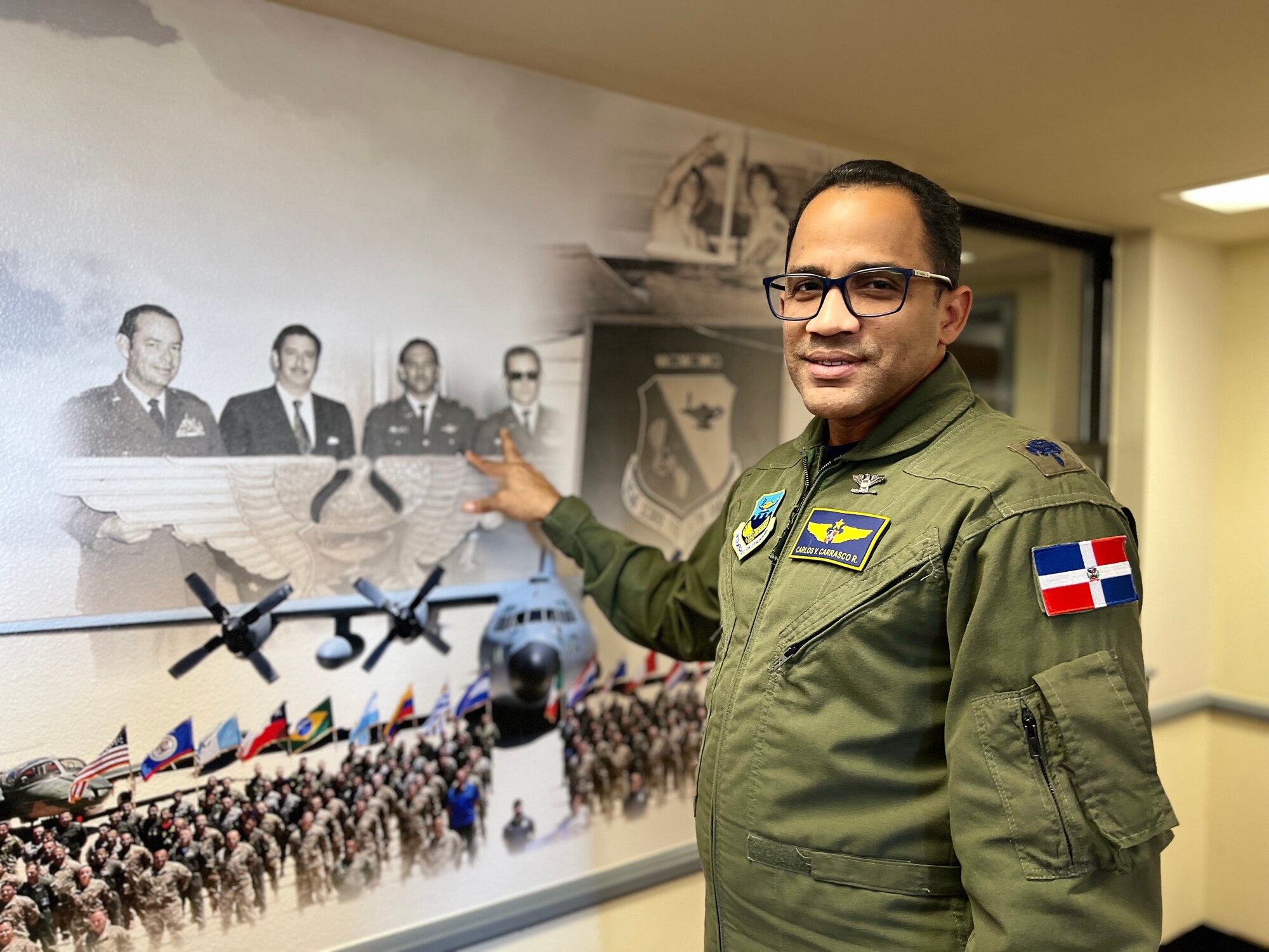 Col Carrasco points to picture on IAAFA heritage wall