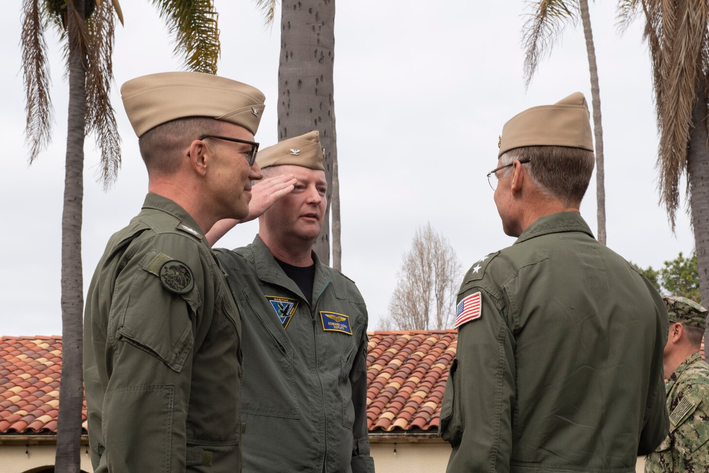 Capt. Edward Hoak (middle), reports to Rear Adm. Scott Jones, Commander, Naval Air Force Reserve (right) to assume command as MSW commodore during a change of command ceremony in the courtyard of the World Famous I-Bar at Naval Base Coronado, Mar. 3.