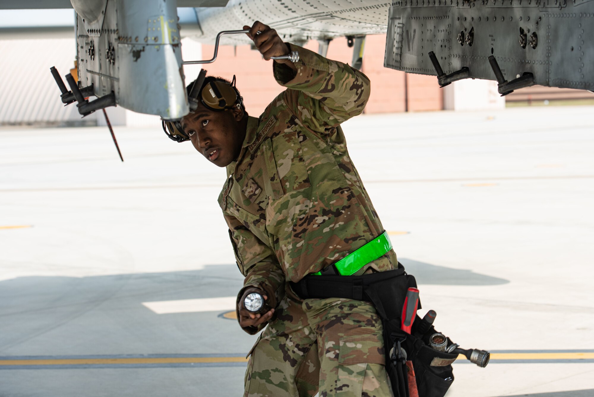 Airman 1st Class Jawuan Johnson, 25th Aircraft Maintenance Unit load crew member, prepares an A-10 Thunderbolt II to receive a load during the 51st Maintenance Group Weapons Load Crew Competition at Osan Air Base, Republic of Korea, April 6, 2022.