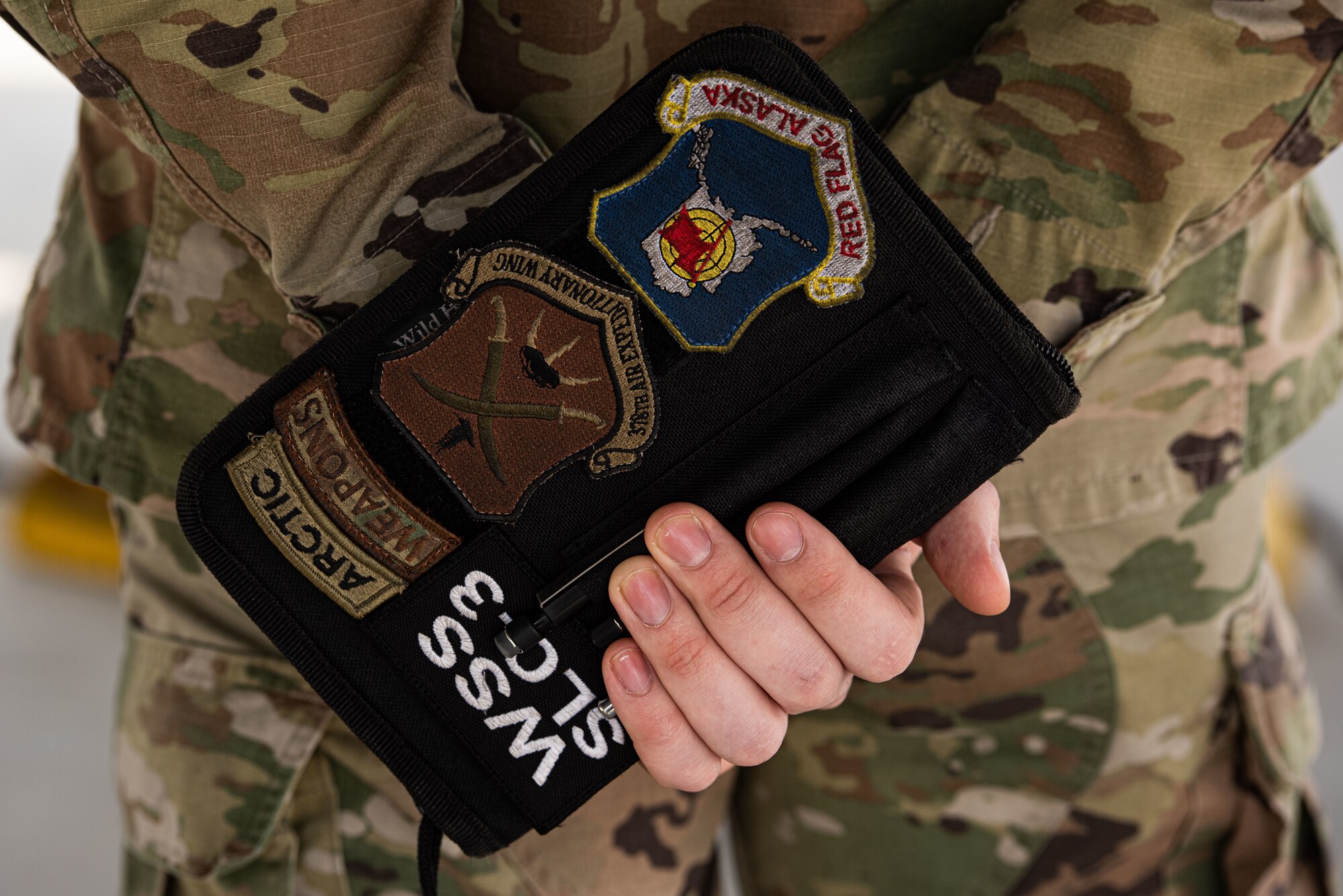 A load crew inspector with the 25th Aircraft Maintenance Unit watches as teams compete during the 51st Maintenance Group Weapons Load Crew Competition at Osan Air Base, Republic of Korea, April 6, 2022.