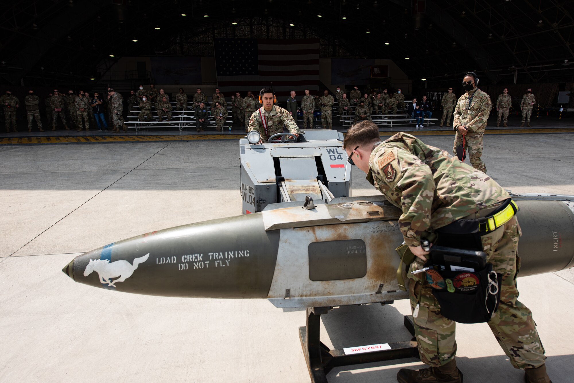 Members with the 36th Aircraft Maintenance Unit compete to win the 51st Maintenance Group Weapons Load Crew Competition at Osan Air Base, Republic of Korea, April 6, 2022.