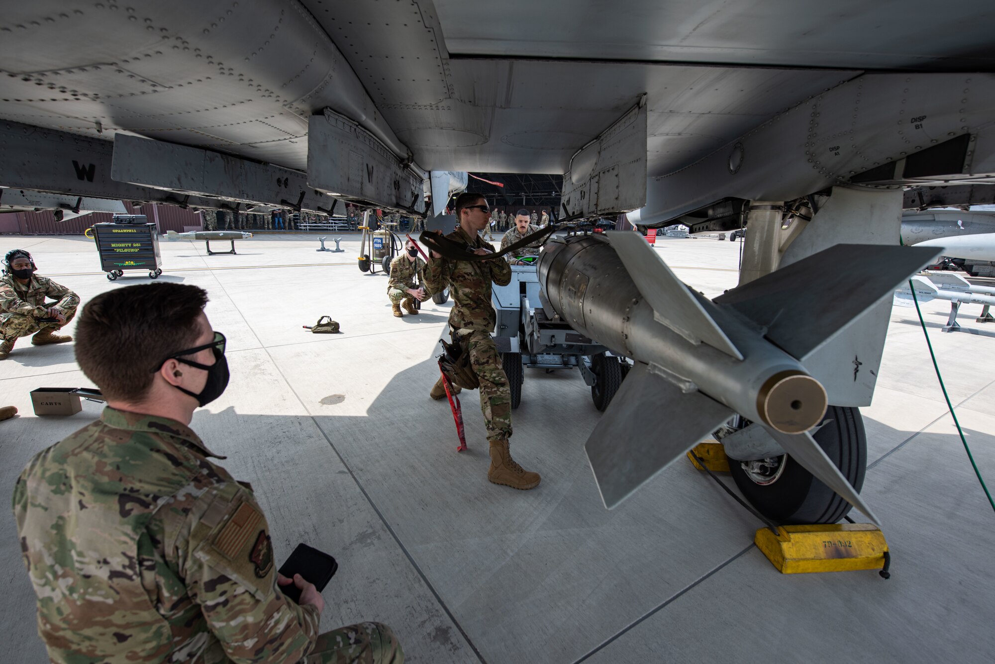 Members with the 25th Aircraft Maintenance Unit load munitions onto an A-10 Warthog during the 51st Maintenance Group Weapons Load Crew Competition at Osan Air Base, Republic of Korea, April 6, 2022.