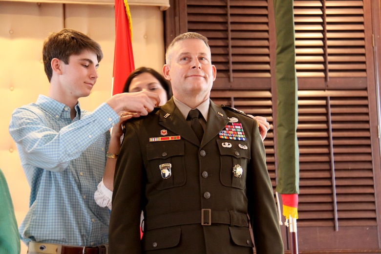 Mason Tickner and Sheri Tickner, son and wife of Maj. Gen. Thomas J. Tickner, pin his major general rank on during Tickner's promotion ceremony at the Fort Hamilton Community Club April 7.