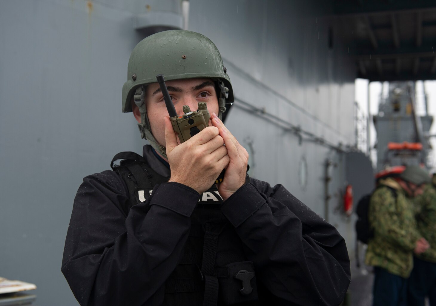 SYDNEY (April 6, 2022) – Gunner’s Mate 3rd Class Christian Freda, from Port Jefferson Station, New York, stands watch as the Emory S. Land-class submarine tender USS Frank Cable (AS 40) departs Sydney, Australia, April 6.  Frank Cable is currently on patrol conducting expeditionary maintenance and logistics in support of national security in the U.S. 7th Fleet area of operations.