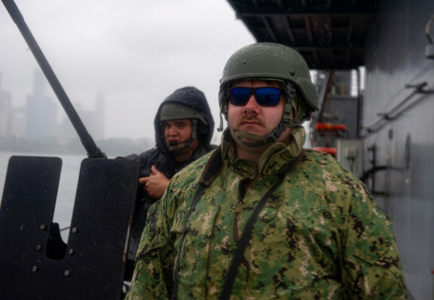 SYDNEY (April 6, 2022) – Master-At-Arms 2nd Class James Phelps, from Indianapolis, (right) and Torpedoman’s Mate 1st Class Robert Hollister, from Camarillo, California, both assigned to the Emory S. Land-class submarine tender USS Frank Cable (AS 40), stand watch as the ship departs Sydney, April 6. Frank Cable is currently on patrol conducting expeditionary maintenance and logistics in support of national security in the U.S. 7th Fleet area of operations.