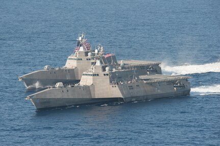 Two ships maneuver in the Pacific.