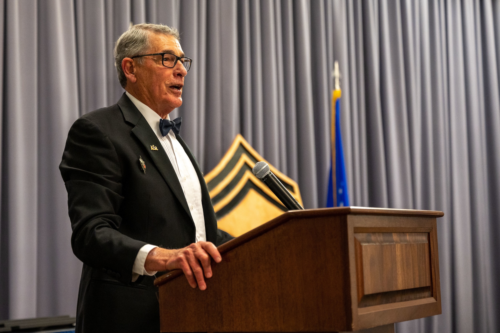 Retired U.S. Army Command Sgt. Maj. George Horvath speaks during the 2022 Chief Induction ceremony at Dover Air Force Base, Delaware, April 2, 2022. Horvath encouraged the new chiefs to look after their Airmen, but also look to other chiefs and officers for guidance while adjusting to the new position. (U.S. Air Force photo by Airman 1st Class Cydney Lee)