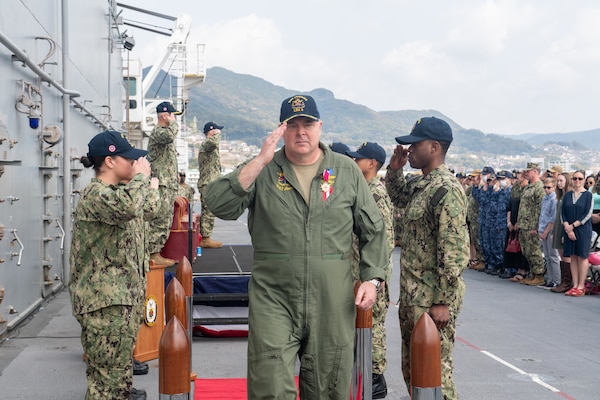 SASEBO, Japan (April 7, 2022) Capt. Ken Ward, sixth commanding officer of the forward-deployed amphibious assault ship USS America (LHA 6), departs the change-of-command on the ship's flight deck. America, lead ship of the America Amphibious Ready Group, is operating in the U.S. 7th Fleet area of responsibility to enhance interoperability with allies and partners, and serve as a ready response force to defend peace and stability in the Indo-Pacific region. (U.S. Navy photo by Mass Communication Specialist Seaman Matthew Bakerian)